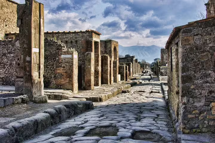 Ancient cobblestone street in Pompeii with ruins, seen on VIP small-group guided tour with included ticket