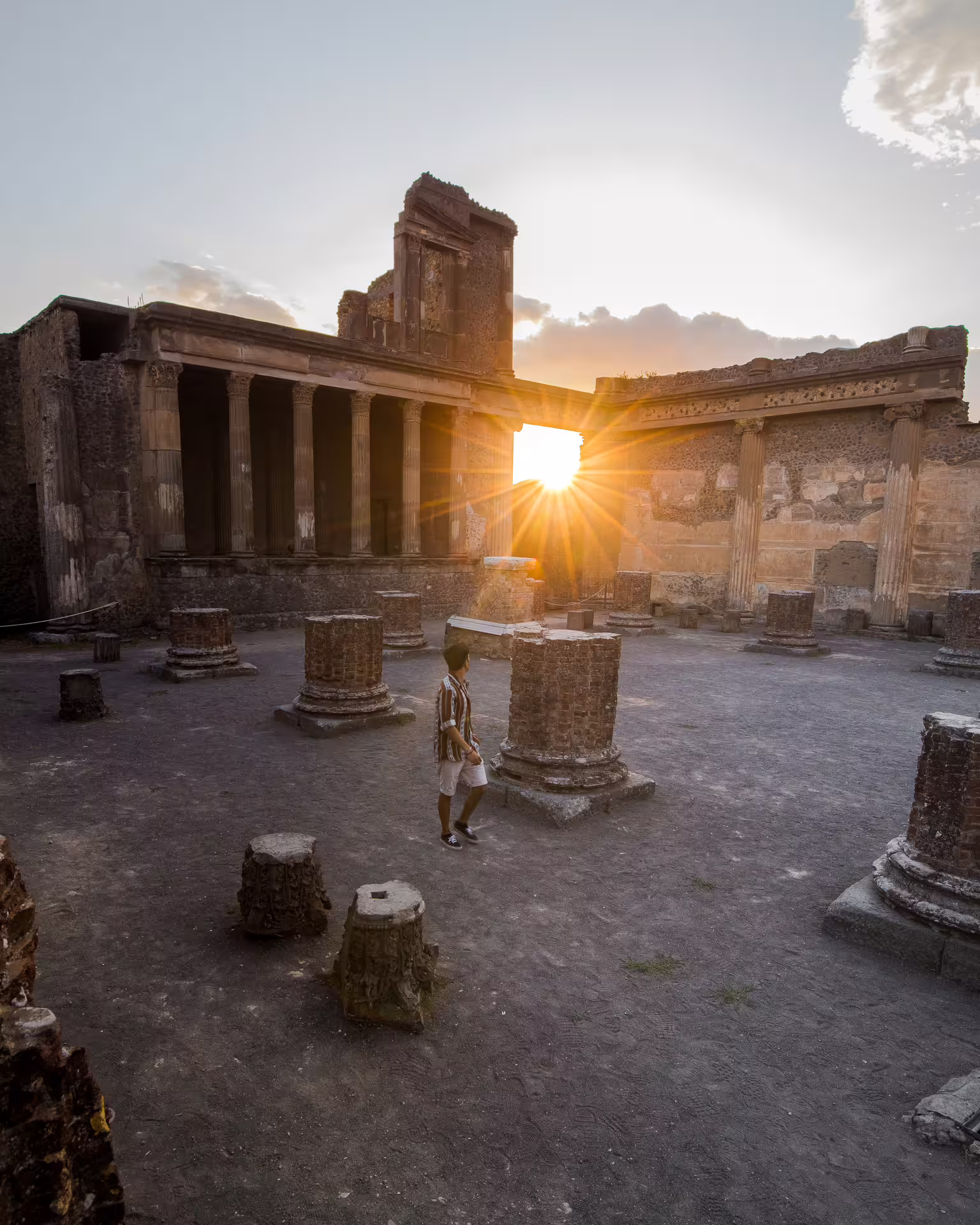 Sunset over Pompeii forum columns during Naples group tour to Pompeii and Herculaneum archaeological sites