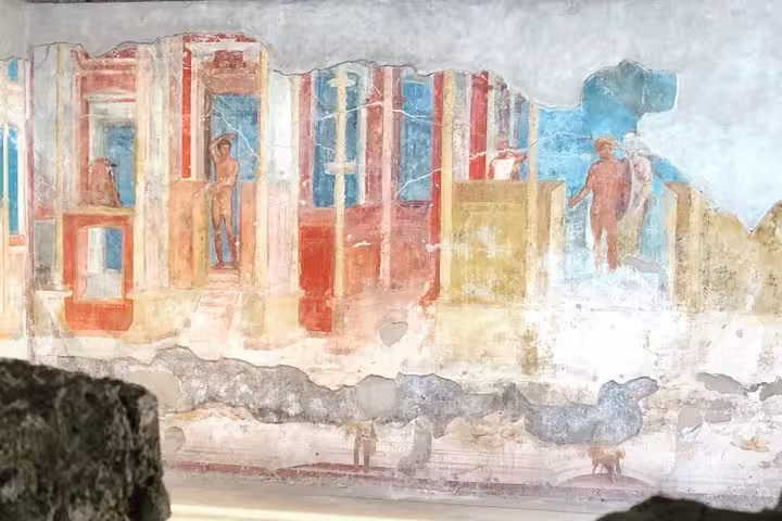 Colorful Pompeii fresco illustrating Roman architecture, part of the Pompeii & Vesuvius with lunch & wine tasting tour.