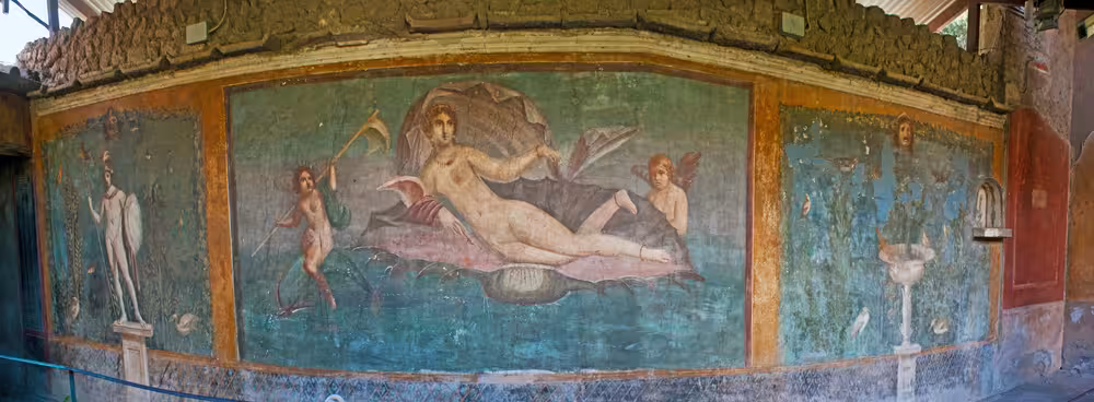 Vibrant frescoes depicting Roman mythology in an ancient Pompeii building on a tour from Rome by minivan.