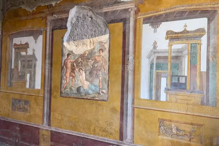 Vibrant frescoes depicting daily life in Pompeii, perfect highlight for Vesuvius tour and wine tasting from Amalfi Coast.