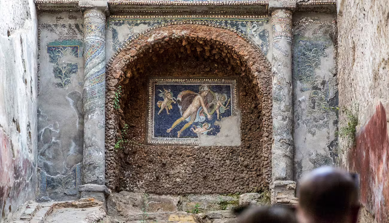 Intricate mosaic artwork displayed in Pompeii ruins, a highlight of the Skip the Line Guided Tour from Naples.
