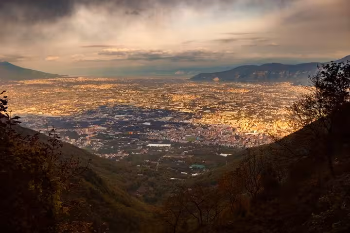 Aerial panoramic view of Pompeii and Naples valley surrounded by mountains at dusk