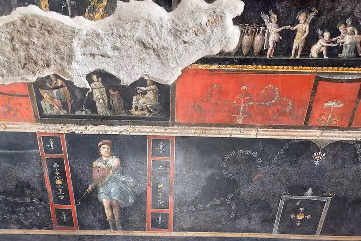 Detailed fresco featuring Roman figures and mythological scenes in Pompeii, highlighting the city's rich cultural history.