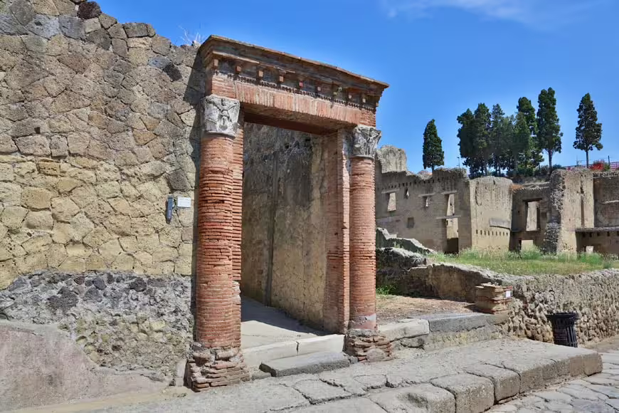 Pompeii ruins brick doorway and stone street on budget Naples to Pompeii and Herculaneum guided tour