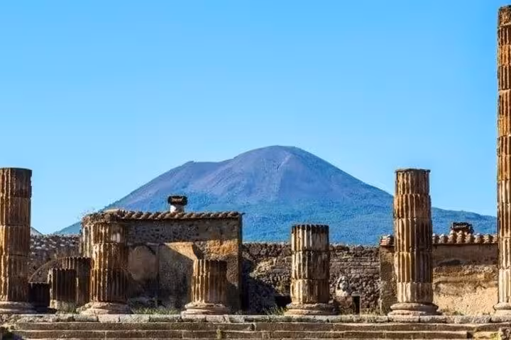 Ancient ruins of Pompeii with majestic Mount Vesuvius in the background, a must-see on the guided tour.