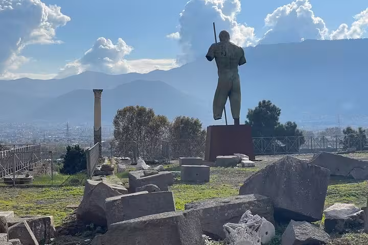 Explore ancient Pompeii ruins with mountainous backdrop on the all-inclusive Amalfi Coast tour.