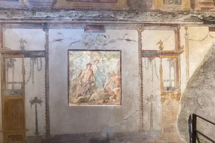 Intricate wall fresco in Pompeii ruins capturing Roman mythology, ideal for cultural exploration from Positano.
