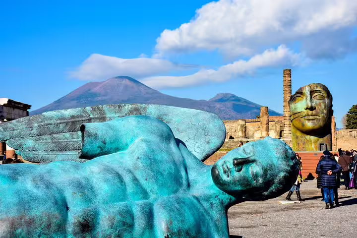 Pompeii sculpture with Mount Vesuvius behind, budget Naples to Pompeii and Vesuvius tour highlight