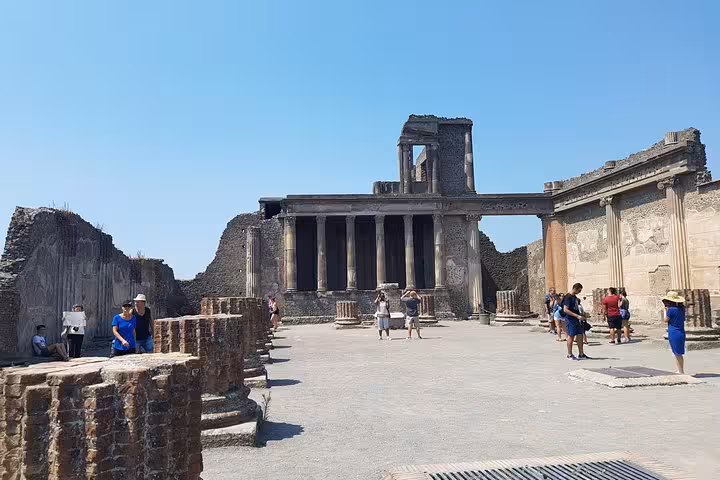 Ancient Pompeii temple ruins under blue sky on a private 6-day tour from Rome to Positano, Sorrento, Amalfi and Capri