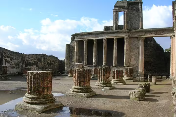 Pompeii temple ruins with tall columns and courtyard, Naples to Pompeii half day group tour with pickup
