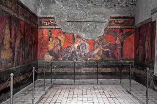 Colorful frescoes in the Villa of the Mysteries at Pompeii, depicting ancient Roman rituals on a guided archaeological tour