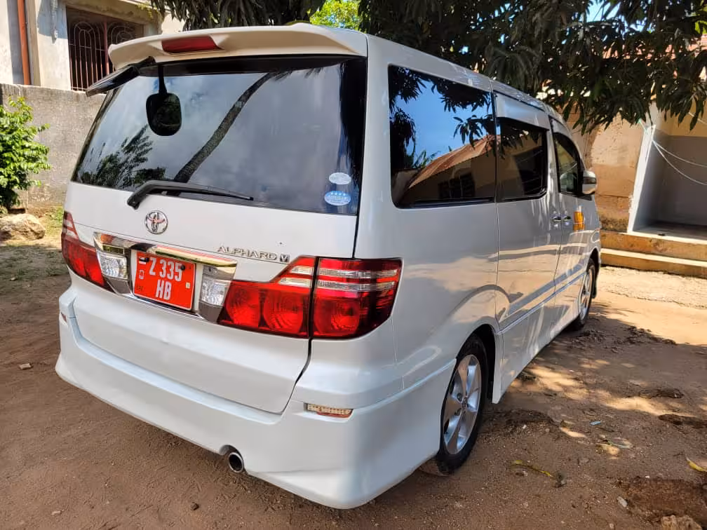 Clean white Toyota Alphard van for private transfer from Pongwe hotels to Zanzibar Airport, offering safe, air‑conditioned rides