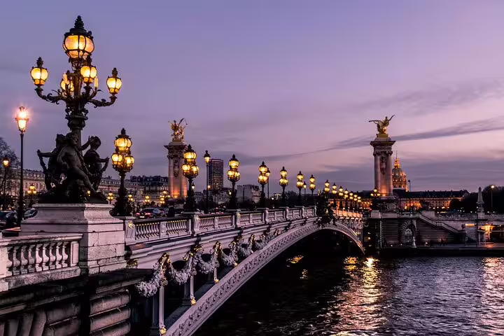 Pont Alexandre III bridge at dusk with ornate golden lampposts and gilded statues in Paris