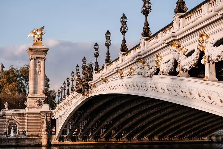 Ornate Pont Alexandre III bridge with gold statues and decorative lampposts over the Seine River in Paris