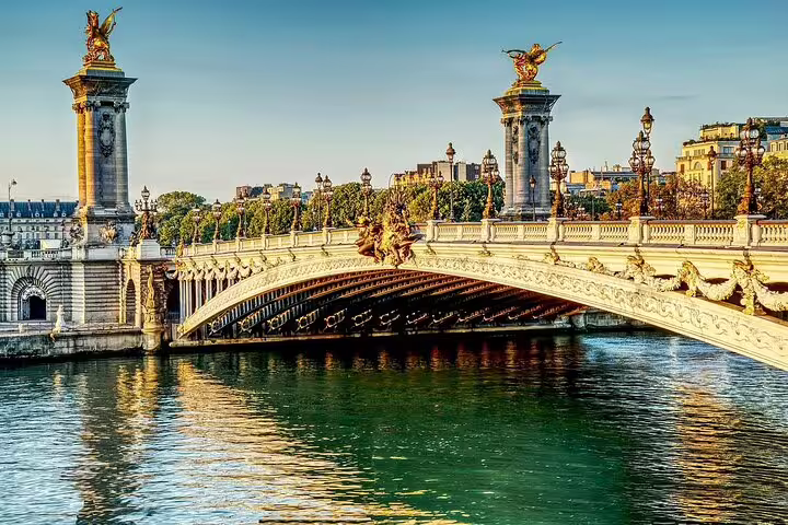 Ornate Pont Alexandre III bridge over the Seine River in Paris with golden statues and decorative lampposts