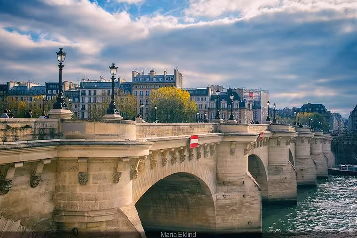 Pont Neuf stone bridge over the Seine River with classic Haussmann buildings in Paris