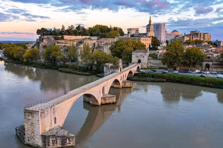 Scenic view of Pont Saint-Bénézet and historic Avignon skyline at sunset on the Provence and French Countryside Tour.