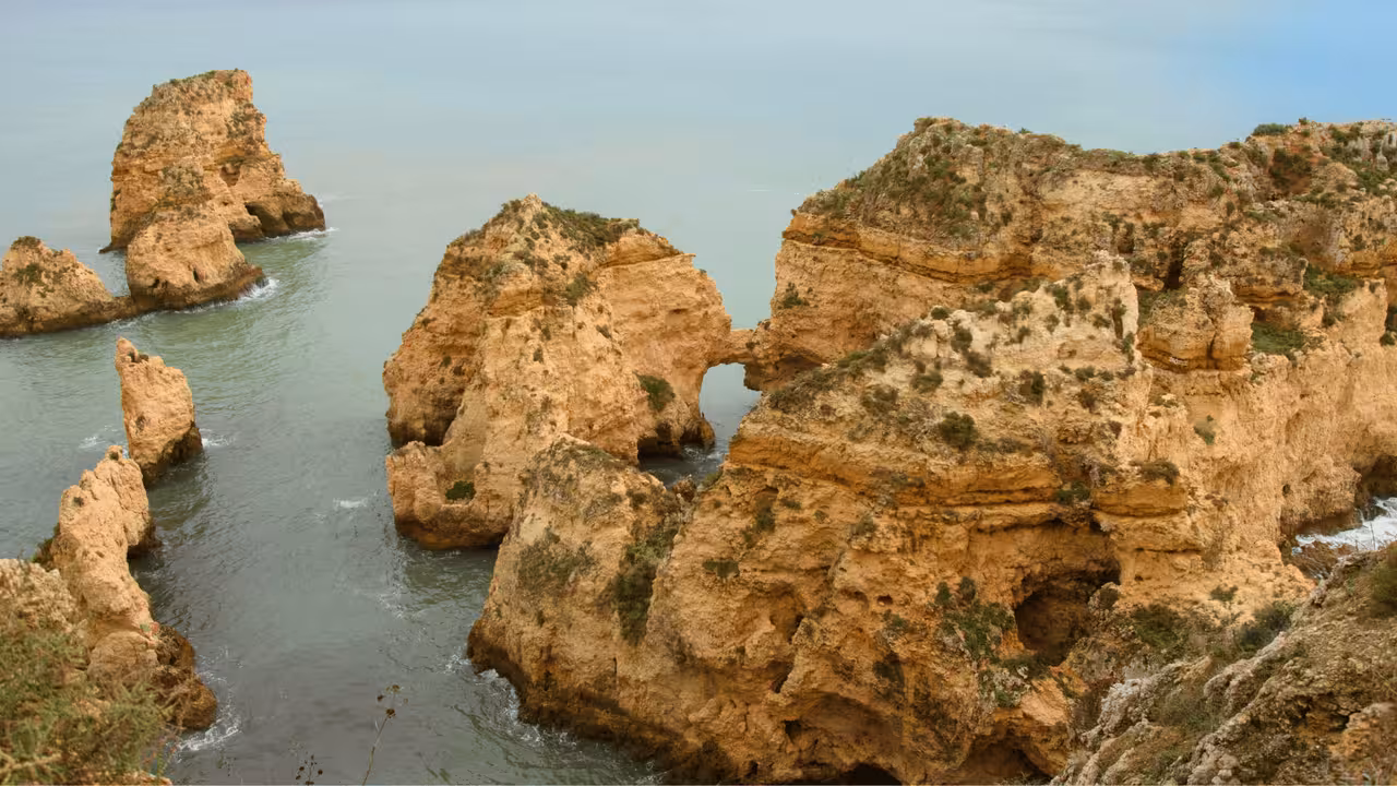 Stunning golden limestone rock formations and sea arches at Ponta da Piedade Lagos Algarve boat tour destination