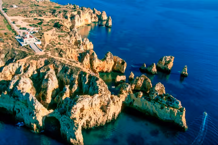 Aerial view of Ponta da Piedade cliffs and sea stacks on a full-day cruise from Lagos, Algarve coast