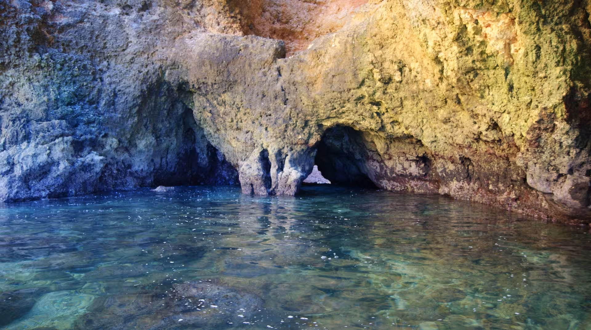 Hidden grotto and clear lagoon at Ponta da Piedade on a Lagos private boat cruise with cave views and swim
