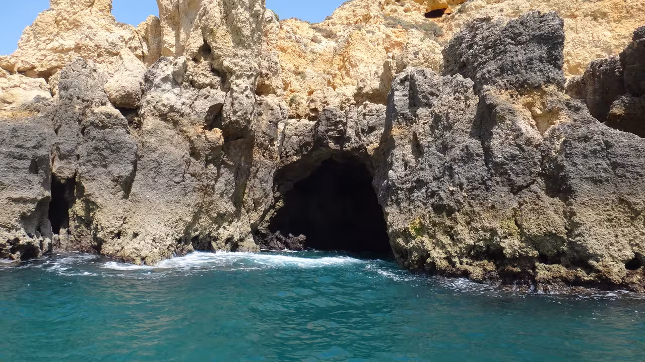 Sea cave at Ponta da Piedade cliffs, Lagos Algarve, viewed from boat cruise on turquoise Atlantic waters