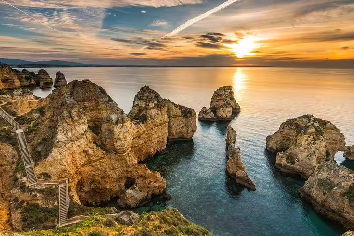 Sunset over Ponta da Piedade's stunning rock formations in Algarve, featured in a private full-day tour from Lisbon to Lagos and Sagres.
