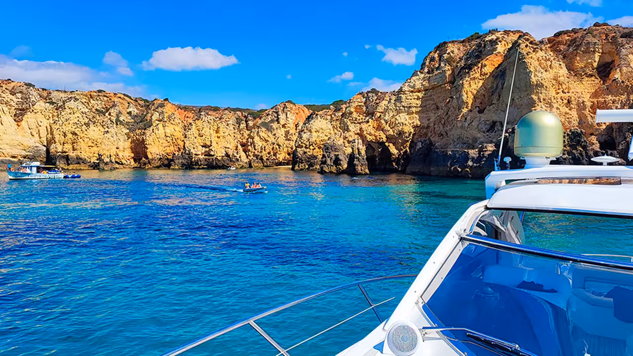 View from yacht of Ponta da Piedade cliffs and turquoise sea in Lagos Algarve on a full-day cruise tour