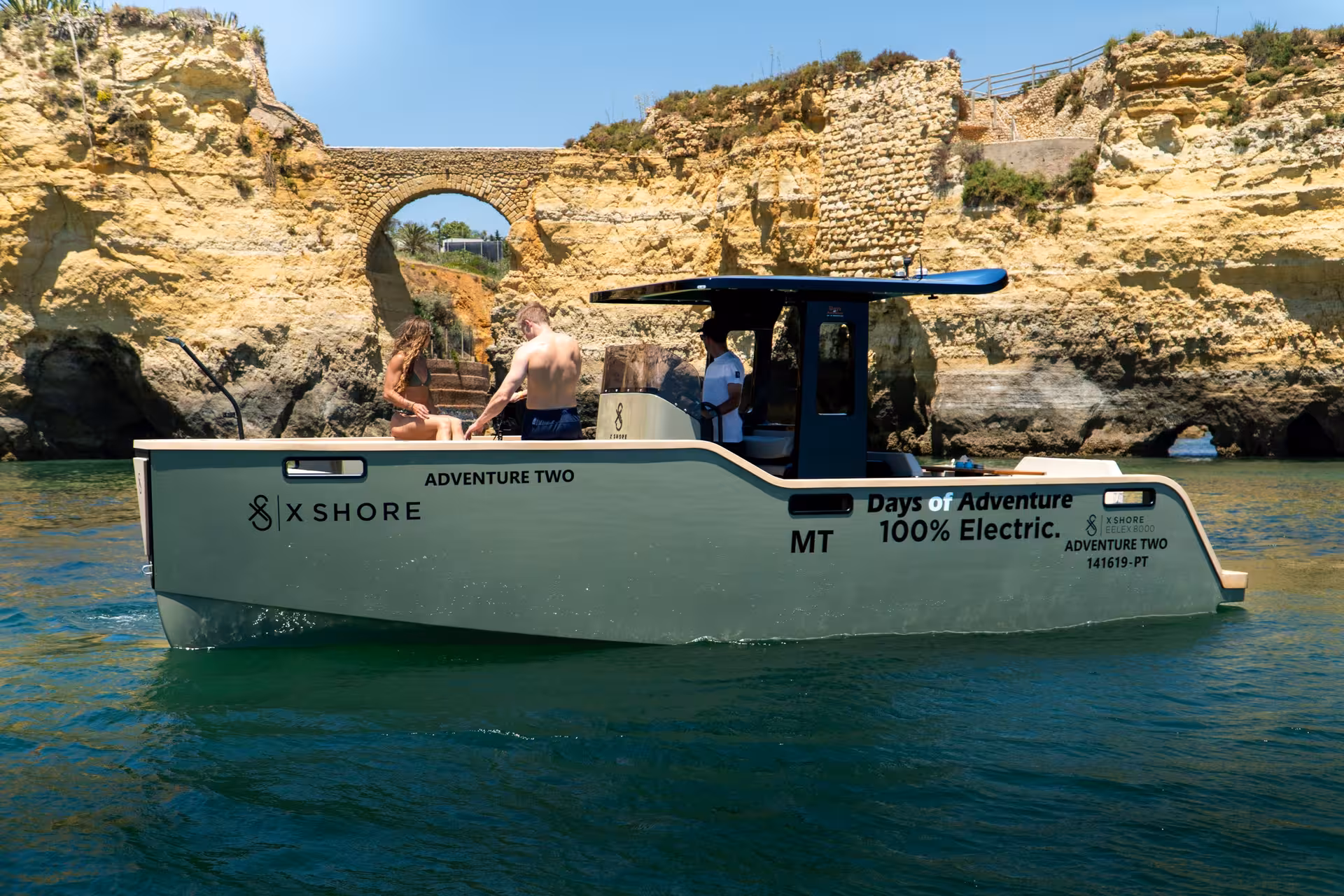X Shore electric boat with guests exploring golden cliffs and sea caves on Ponta da Piedade private tour Lagos