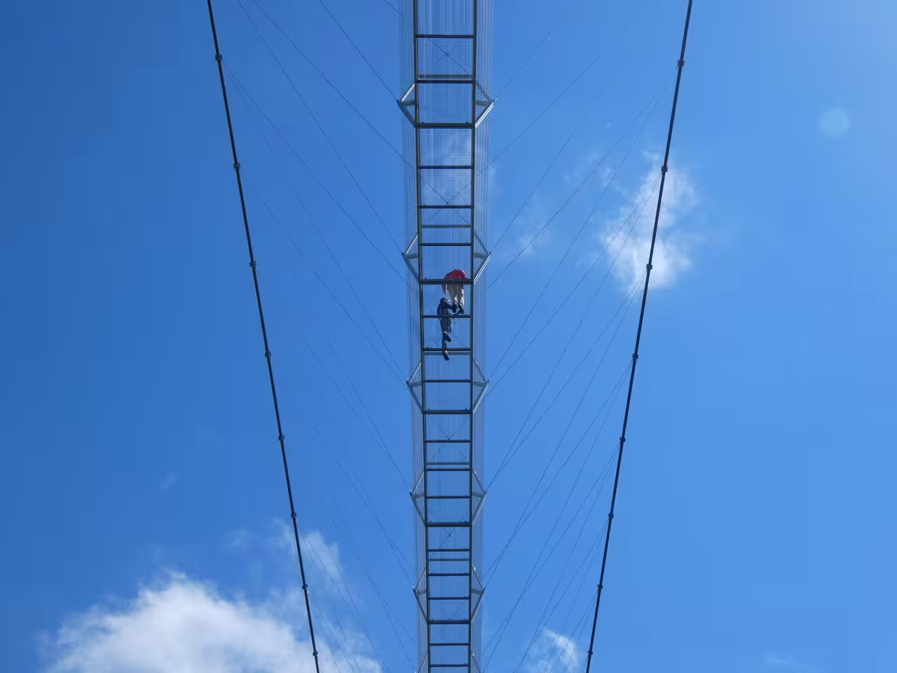 Traveler crossing Ponte 516 Arouca suspension bridge on Porto day trip with Paiva Walkways adventure