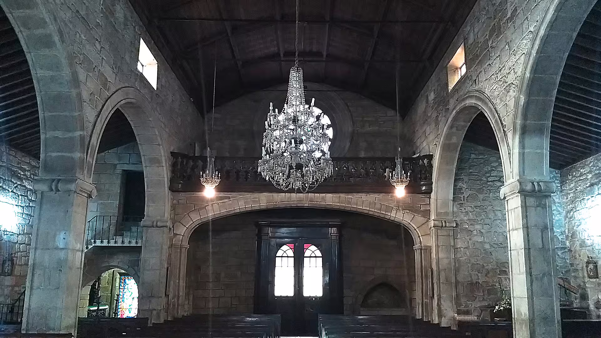 Interior of historic church in Ponte de Lima with elegant chandelier, showcasing cultural heritage on a Vinho Verde private tour.