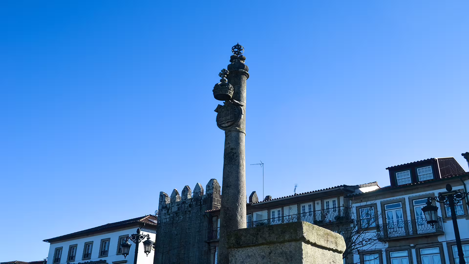 Historic stone monument in Ponte de Lima's scenic town square, highlighting cultural charm on a Vinho Verde private tour.