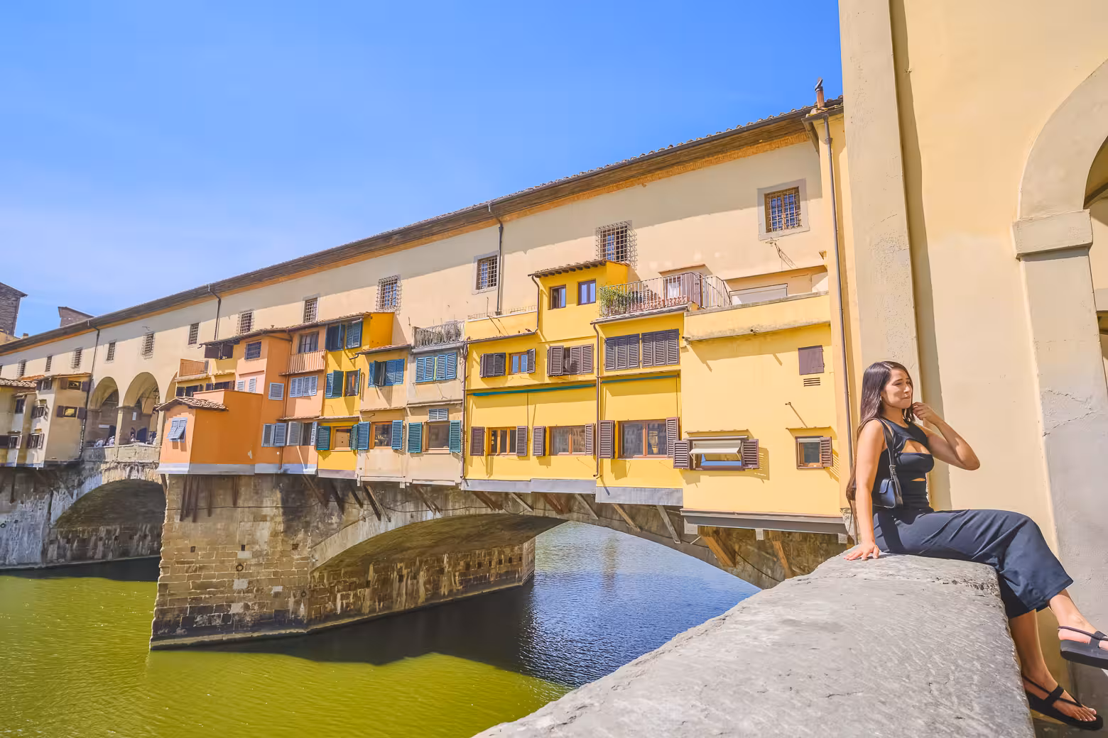 Experience the charm of Ponte Vecchio as a visitor enjoys the view, part of a Livorno to Florence excursion.