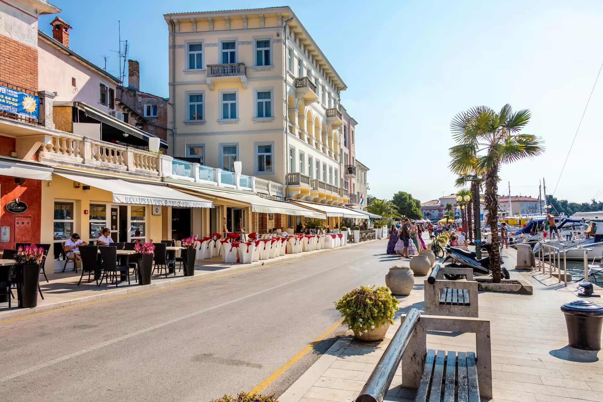 Porec waterfront promenade with cafes and palm trees, stop on the Ancient Istria tour from Pula via Rovinj