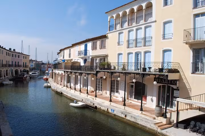 Colorful waterfront buildings and canal with boats in Port Grimaud, French Riviera