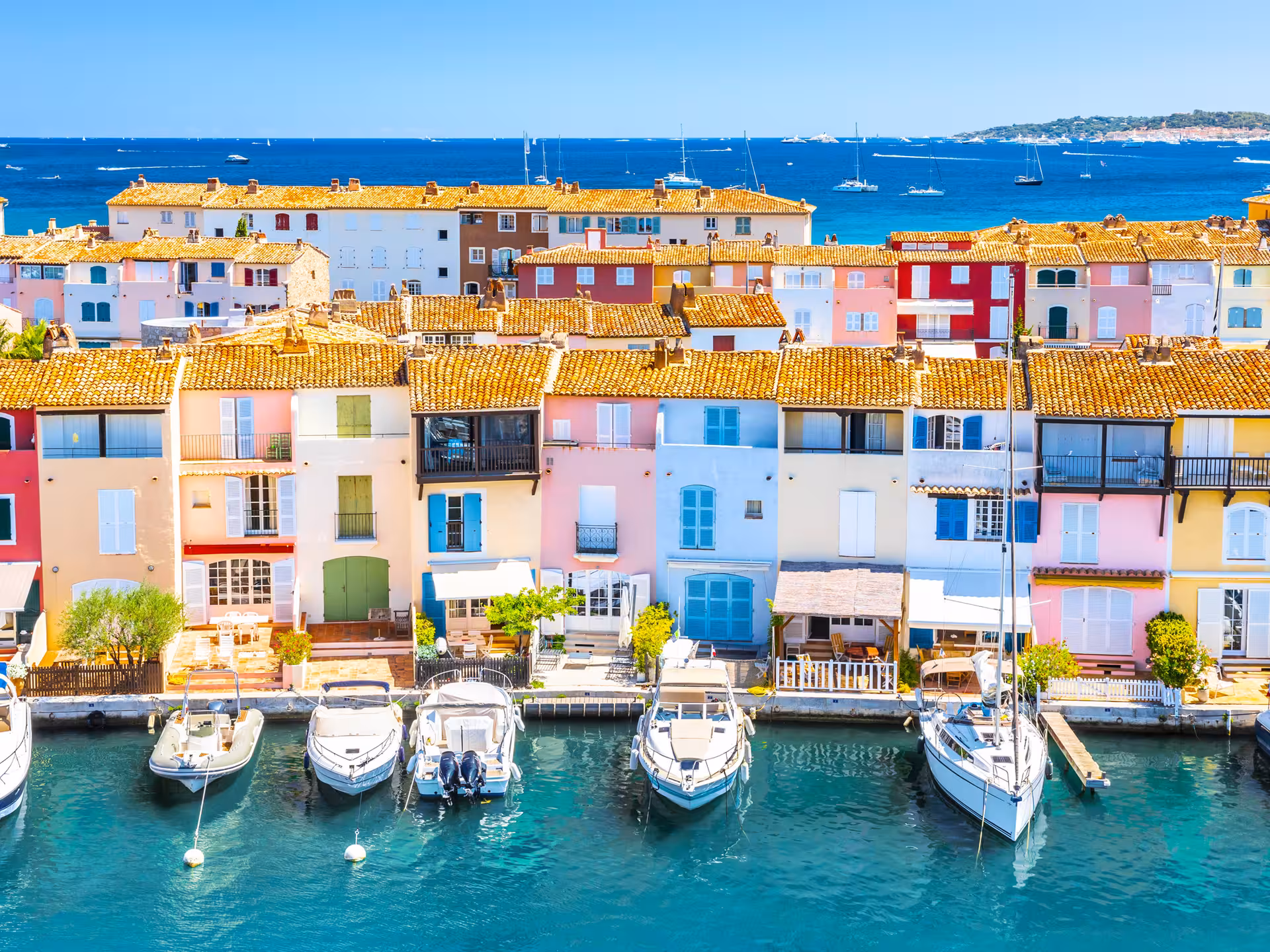 Colorful waterfront houses with moored boats at Port Grimaud marina, French Riviera