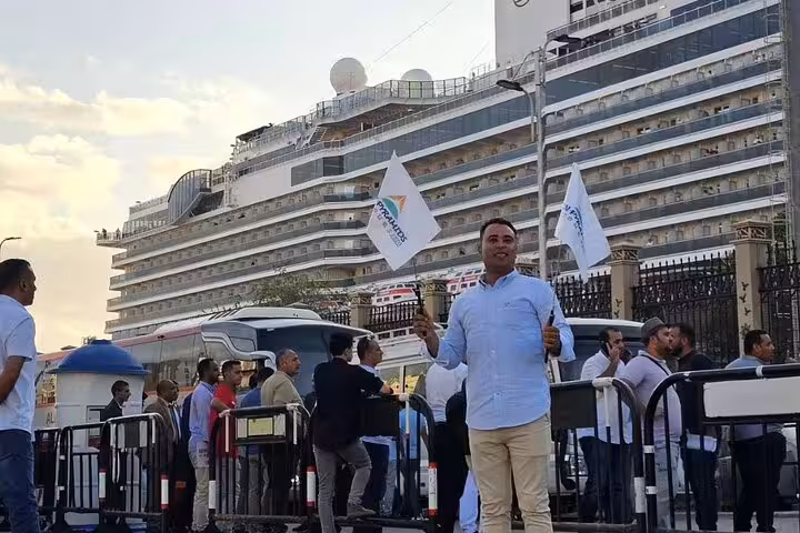 Port Said cruise terminal pickup for 2-day Cairo and Alexandria tour, guide greeting guests outside the ship