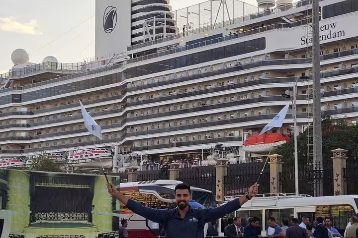 Port Said cruise pickup for Giza Pyramids and Grand Egyptian Museum tour, guide waving flag at port