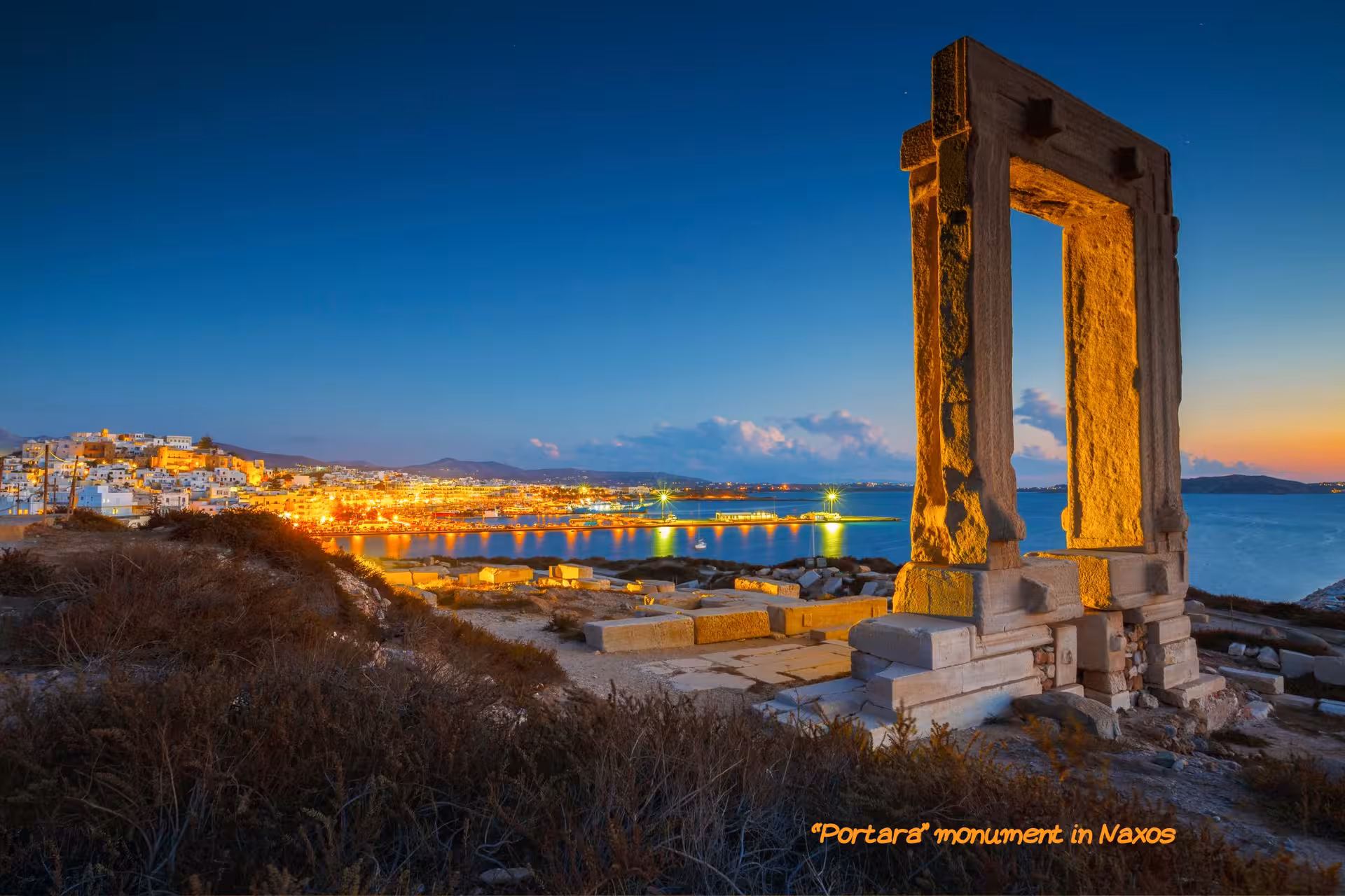 Portara Temple of Apollo at dusk in Naxos with harbor lights, scenic stop on Athens island hopping to Mykonos