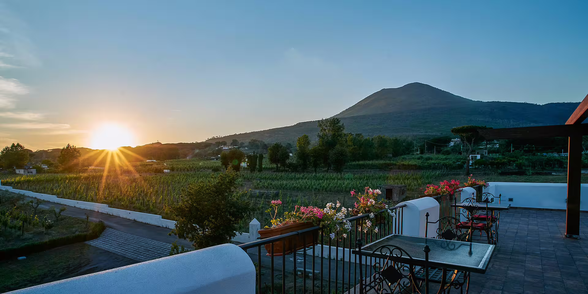 Sunset view from Portici Palace terrace over vineyards and Mount Vesuvius, luxury wine tasting tour