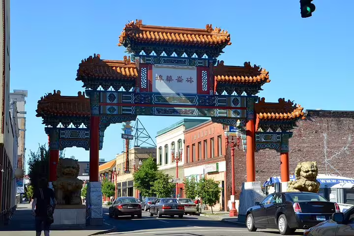 Ornate red Chinese gate with golden lion statues marking Portland's Chinatown district entrance