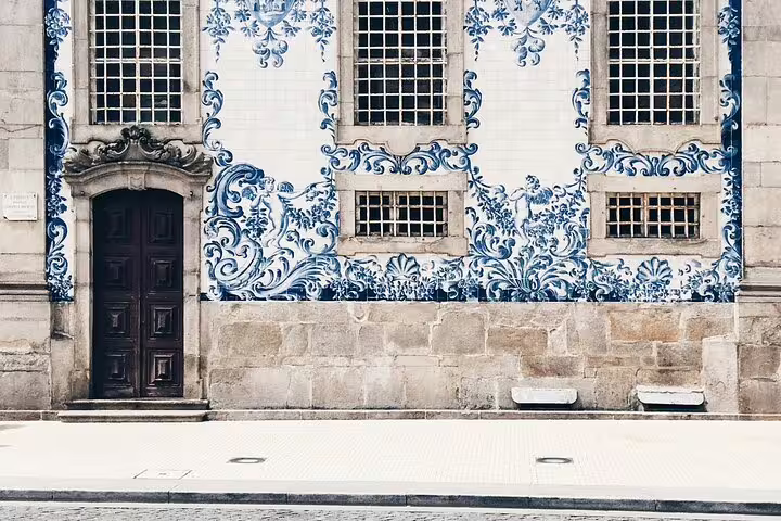 Close-up of traditional blue azulejo tiles on a historic Porto building, showcasing Portuguese architecture.