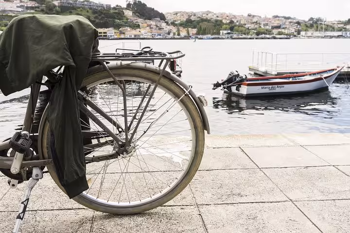 Bicycle parked by the Douro River in Porto, showcasing picturesque views on a small-group cycling tour.