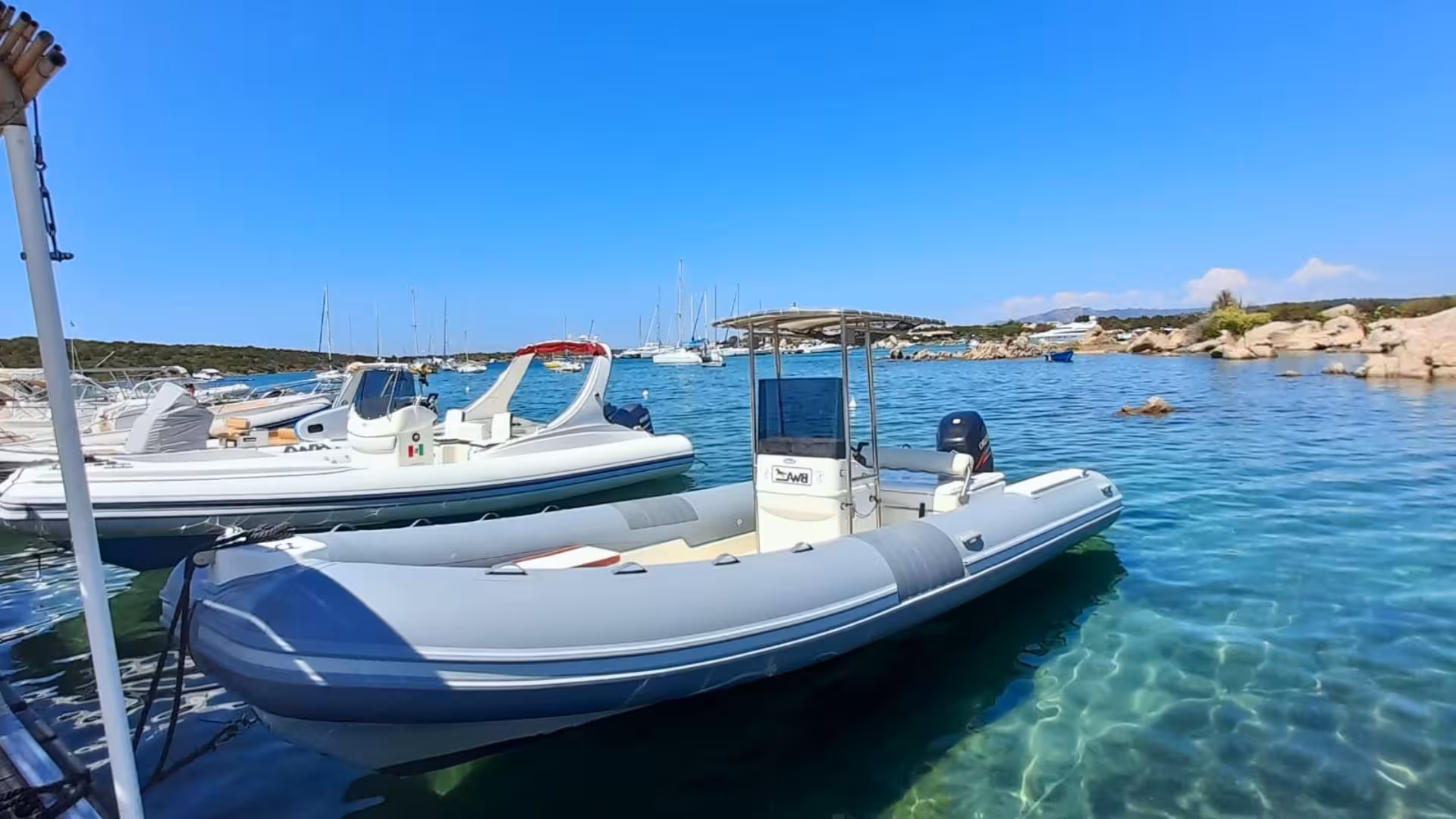 Explore Porto Cervo's pristine waters with a modern dinghy tour departing from Porto Rotondo, offering stunning views.