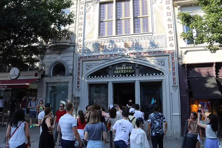 A group of tourists visits the iconic Livraria Lello bookstore in Porto, known for its stunning architecture.