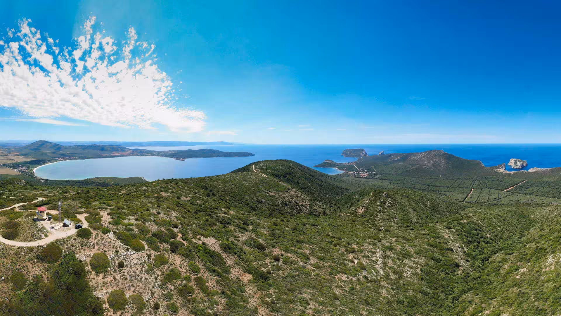 Panoramic view of lush landscapes and coastline at Porto Conte Park Ecomuseum, Alghero, ideal for nature lovers.