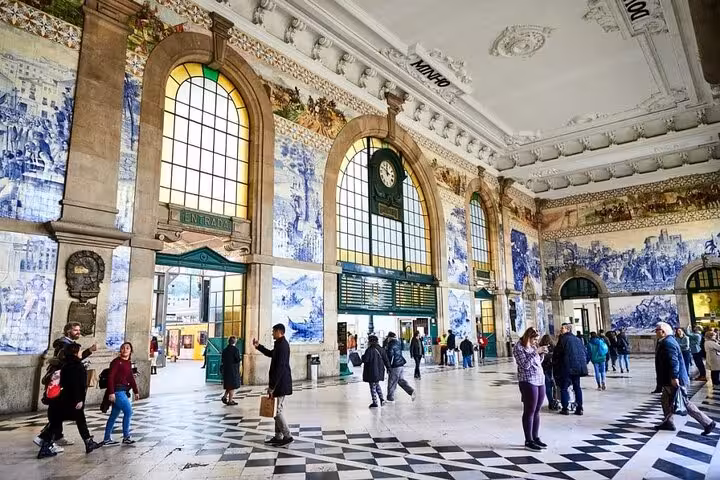 Experience Sao Bento Station's iconic azulejos and vibrant atmosphere on a full-day Porto tour departing from Lisbon.