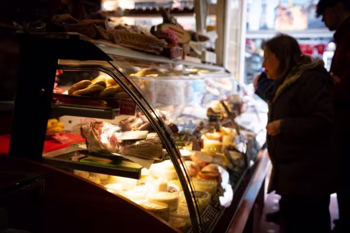 Cozy Porto deli with a variety of local cheeses and meats, inviting exploration on a Porto food tour.