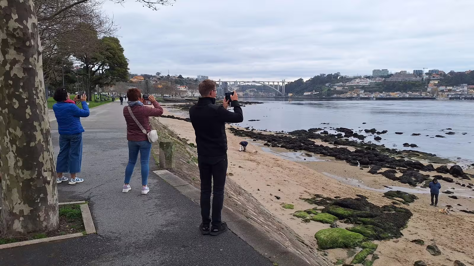 Tourists capture scenic views along Porto's Douro River during a private afternoon tour with local experts.