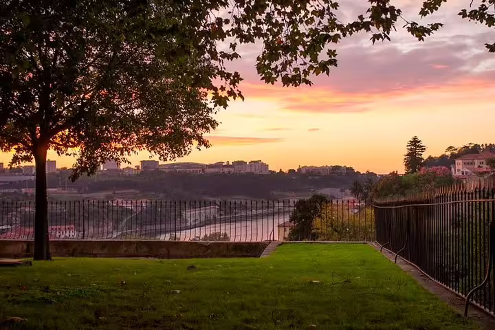Sunset over the Douro River viewed from a tranquil park in Porto on the Jewish Heritage Walking Tour.